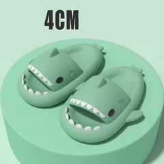 Cartoon Shark Slippers on a green pedestal, showcasing 4cm thick sole and playful shark design.