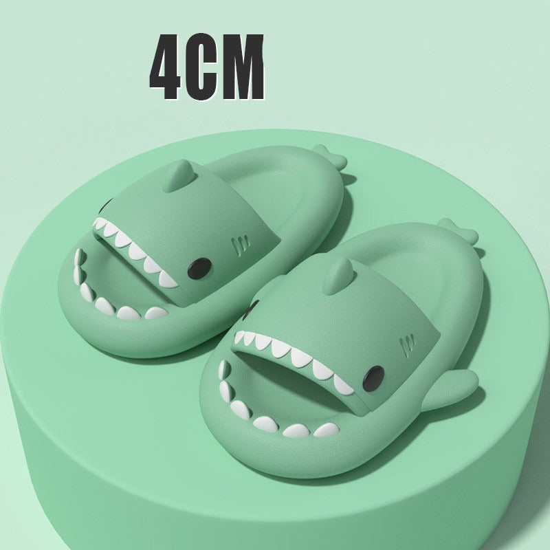 Cartoon Shark Slippers on a green pedestal, showcasing 4cm thick sole and playful shark design.