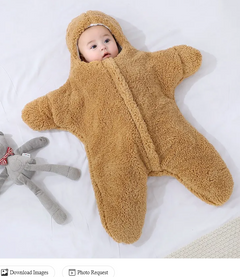 Baby Quilt - Soft & Cozy Newborn baby wrapped in a plush, pink snowsuit on a soft surface.