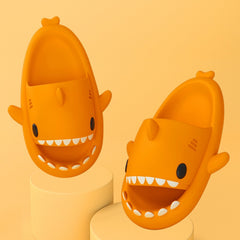 Cartoon Shark Slippers on a green pedestal, showcasing 4cm thick sole and playful shark design.