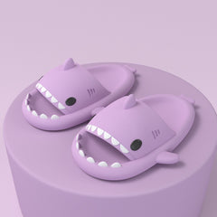 Cartoon Shark Slippers on a green pedestal, showcasing 4cm thick sole and playful shark design.
