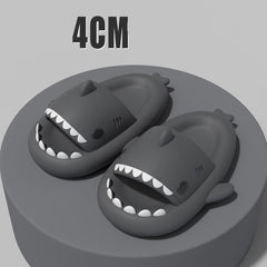 Cartoon Shark Slippers on a green pedestal, showcasing 4cm thick sole and playful shark design.