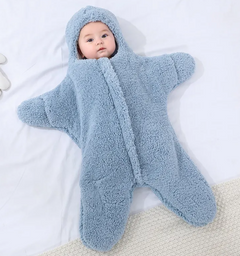 Baby Quilt - Soft & Cozy Newborn baby wrapped in a plush, pink snowsuit on a soft surface.