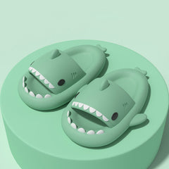 Cartoon Shark Slippers on a green pedestal, showcasing 4cm thick sole and playful shark design.