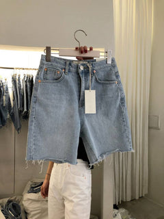 Women's Five-Point Denim Shorts on display, featuring a high waist and loose casual fit, perfect for summer fashion.
